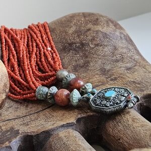 Vibrant Red Beaded Necklace with Intricate Silver Pendant